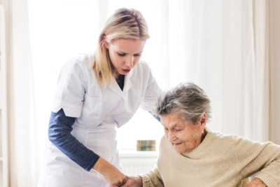 young lady assisting the old woman